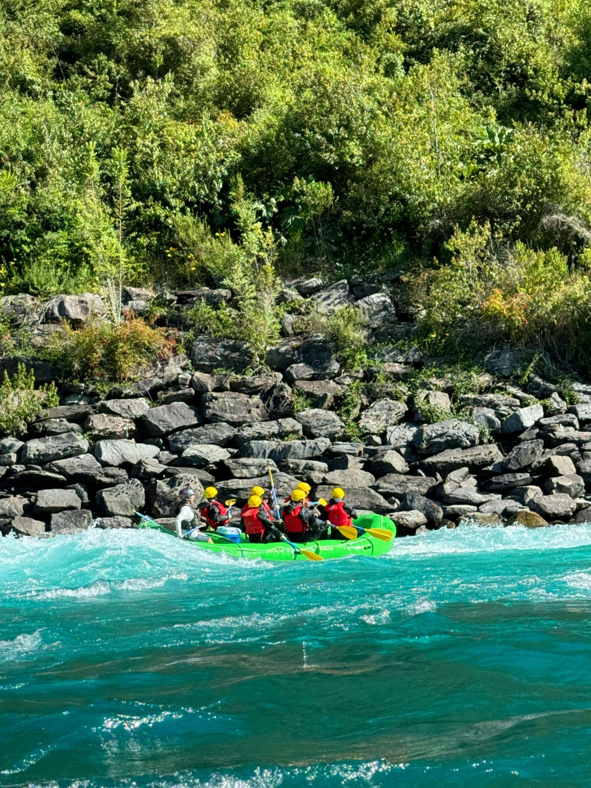 a group of persons enjoying rafting in clear water in a river in India used by a tour planner website Adventure Tunes