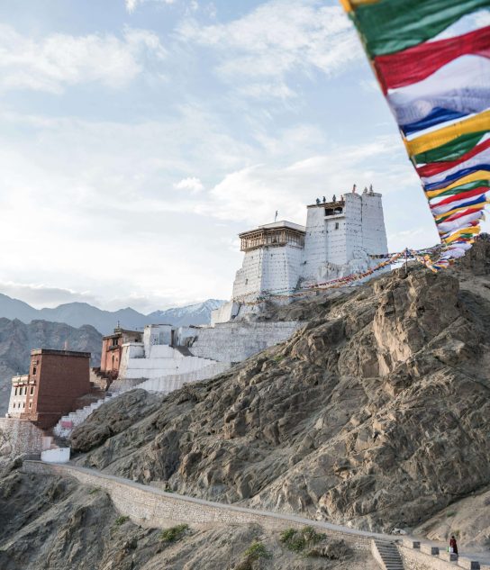 a place in Ladakh presenting a mountain view and Tibetan flag/ Ladakh flag